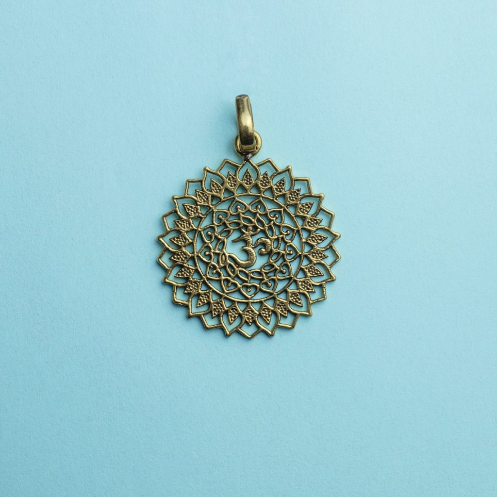 a gold pendant on a blue background