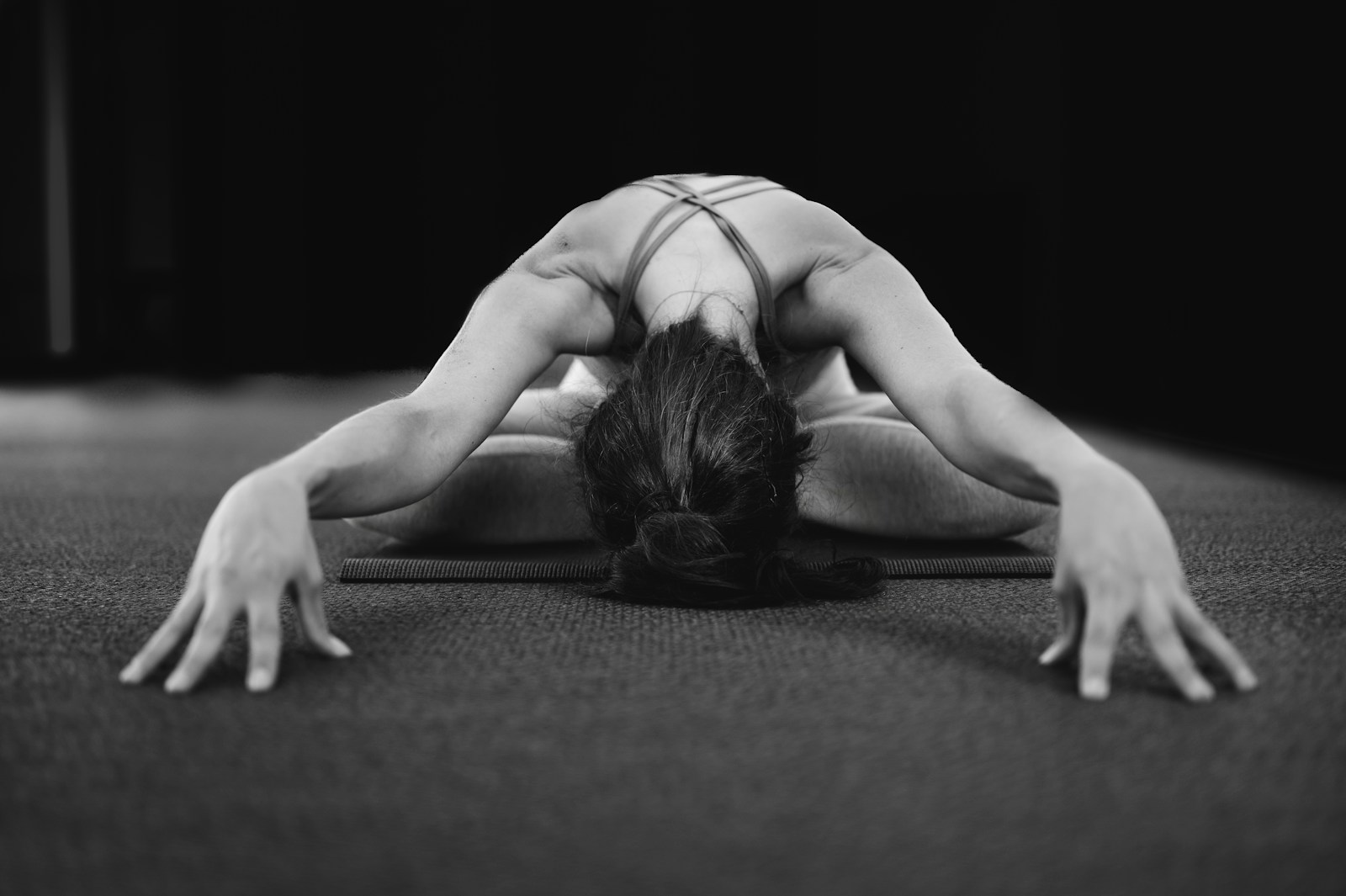 Photo by THLT LCX woman in white tank top bending her body on floor